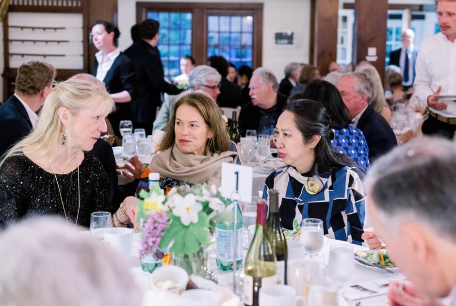 Guests sit at a table in conversation