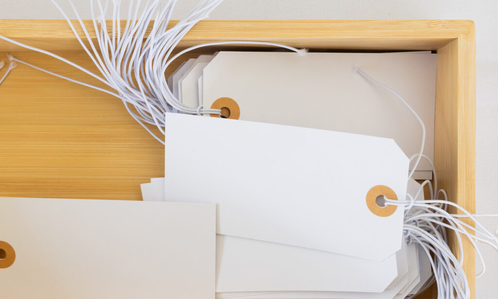 A bamboo box holds white tags to be used for the Wish Tree