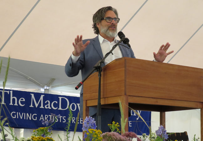 Michael Chabon speaks at the podium on the Medal Day stage