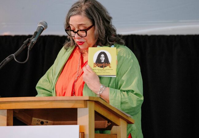 Nora Halpern displays Yoko Ono's Grapefruit as she delivers introductory remarks about the 2024 Edward MacDowell Medalist.