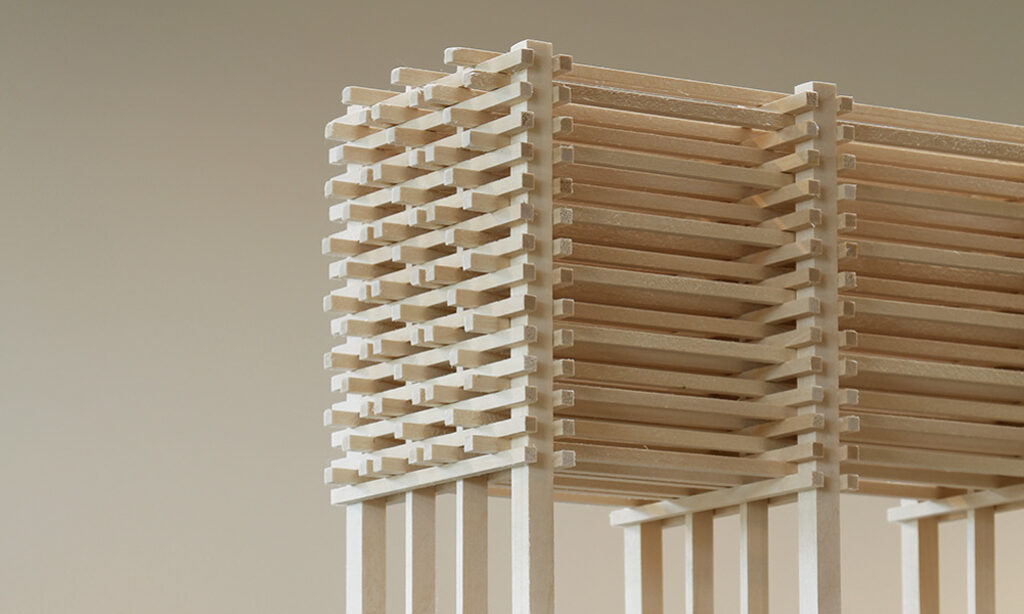 A wooden model of centotaph: a box-like structure of stacked beams.